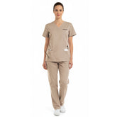 Model wearing the modern vicogard Pro Custom Unisex Scrub Set in Sand