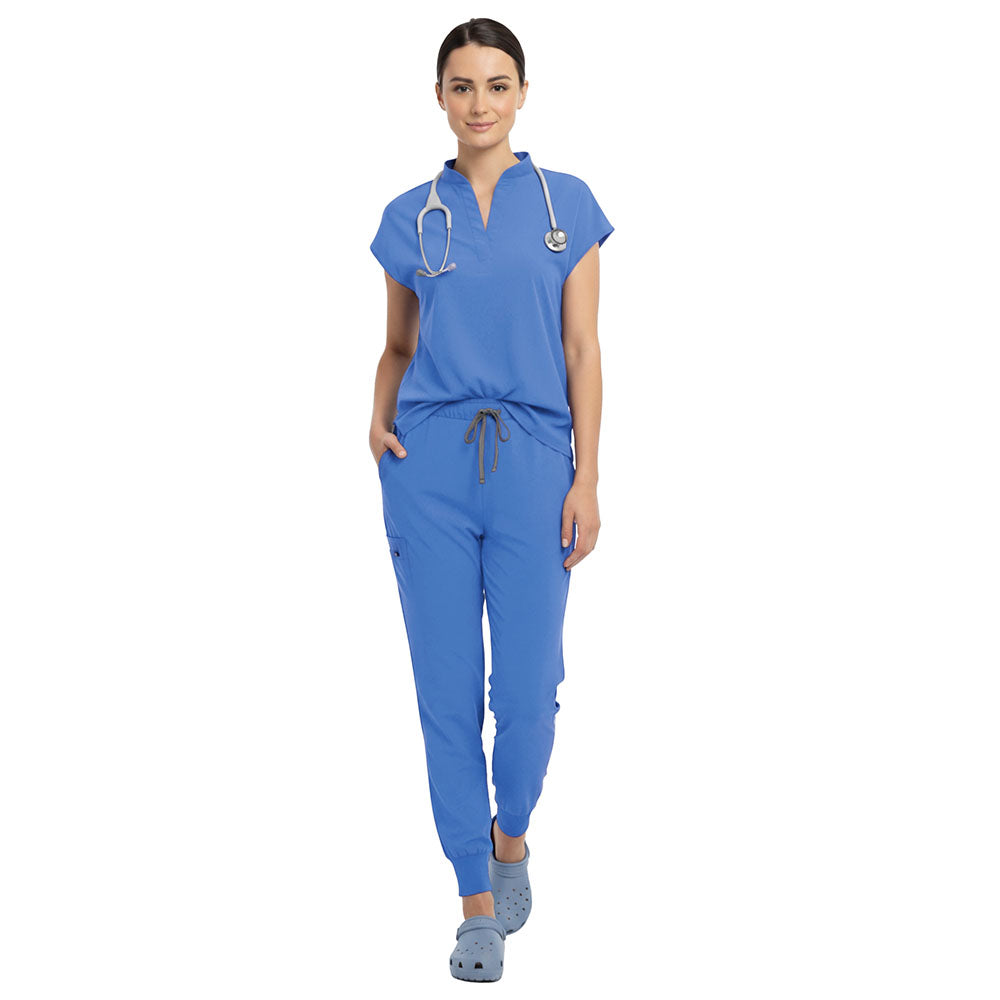 Nursing student wearing Ceil Blue sterile-safe scrubs in a standard hospital setting