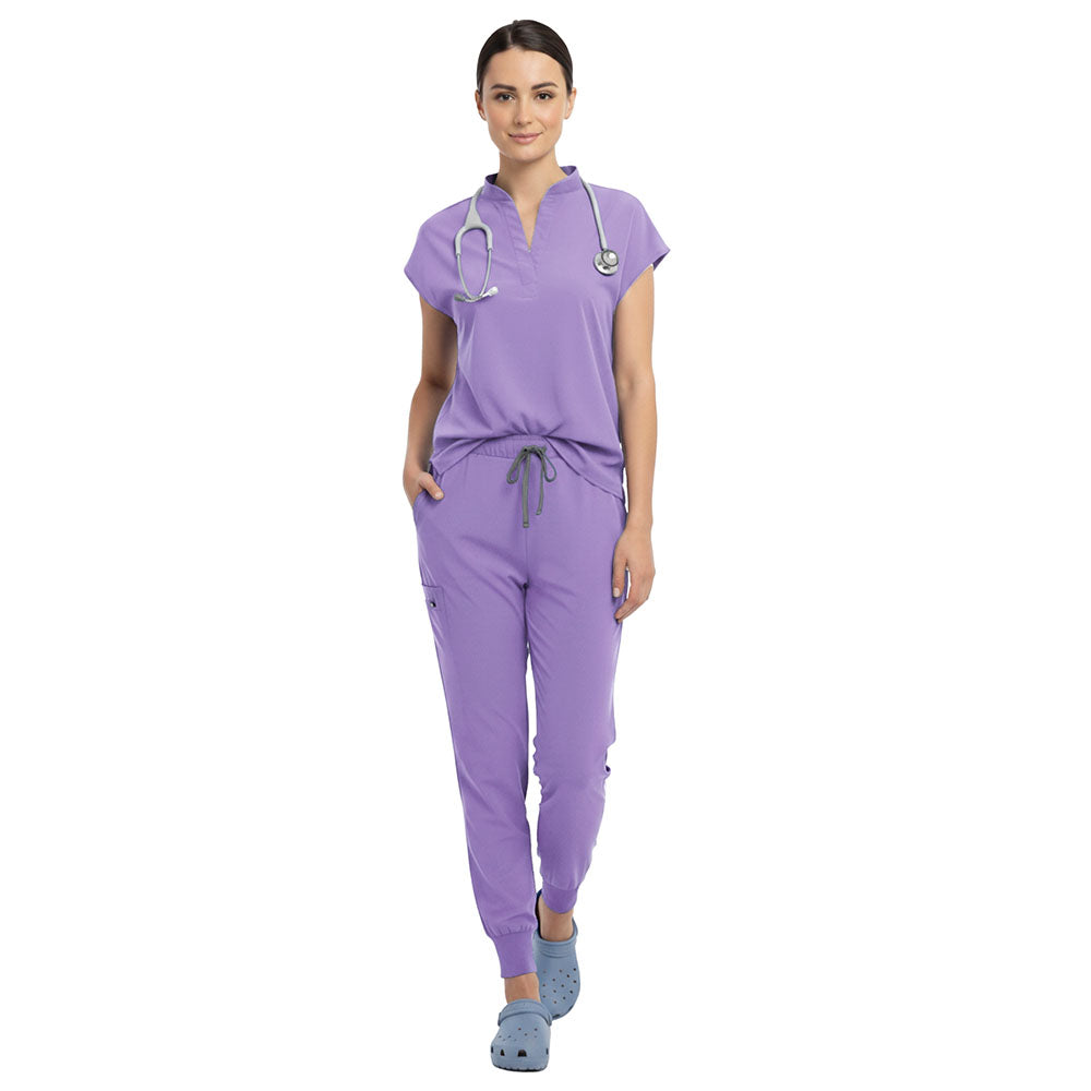 Nurse wearing Lavender sterile-safe scrubs in a calming nursing home setting