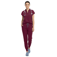 Senior nurse wearing Burgundy sterile-safe scrubs in a professional medical setting