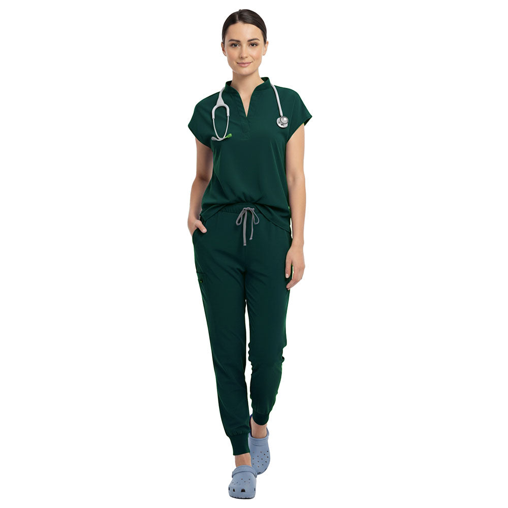 Surgeon wearing Hunter Green sterile-safe scrubs in a standard operating room