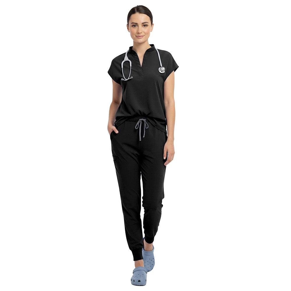 Plastic surgeon wearing Black sterile-safe scrubs in a professional clinic setting