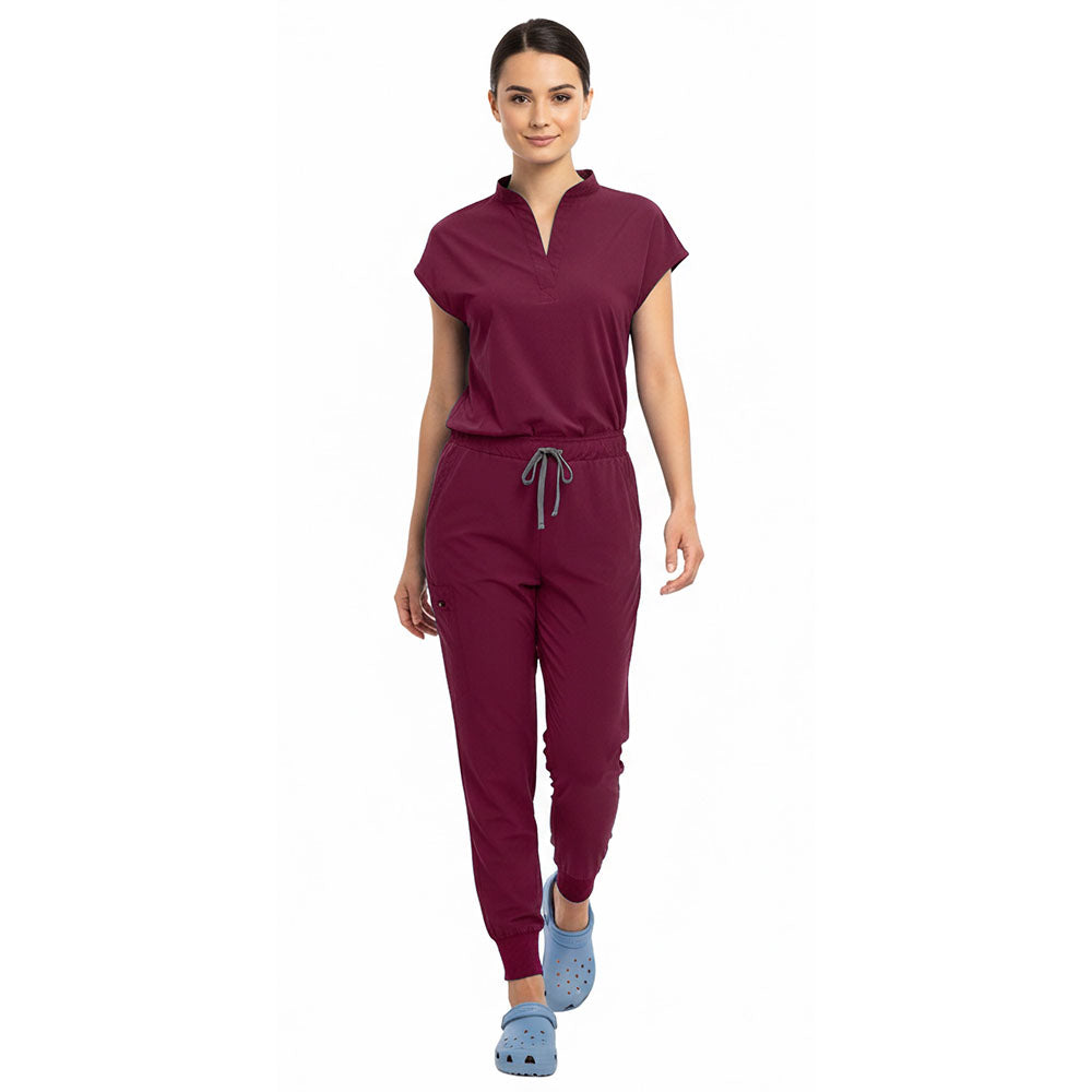 Medical professional stretching in Burgundy 4-way stretch uniform showing flexibility