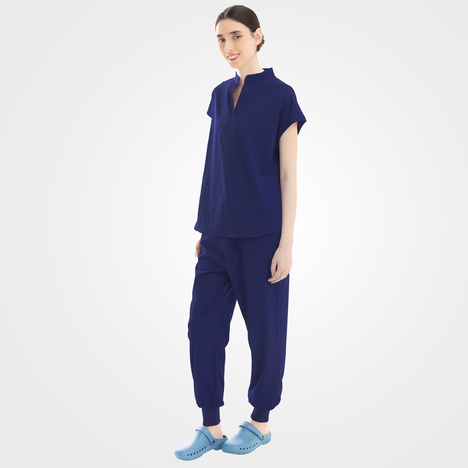 Dark blue scrubs side profile showing hidden pockets and cargo zipper