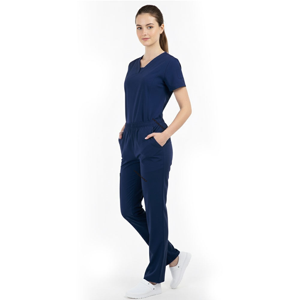Model placing hand in pocket of Navy Blue scrub pants, showing functionality