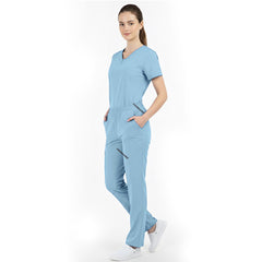 Model placing hand in pocket of Ceil Blue scrub pants, showing functionality