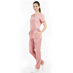 Model placing hand in pocket of Pink scrub pants, showing functionality