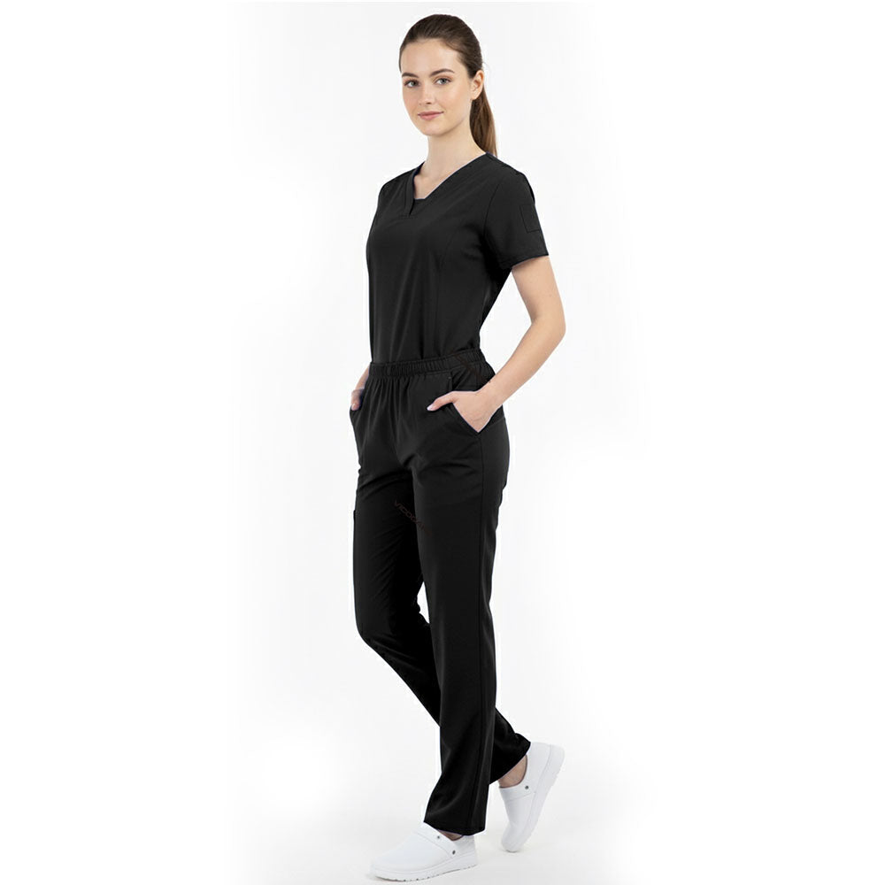 Model placing hand in pocket of Black scrub pants, showing functionality