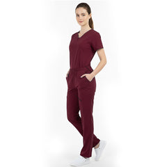 Model placing hand in pocket of Burgundy scrub pants, showing functionality