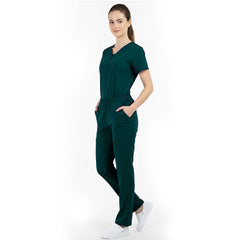 Model placing hand in pocket of Hunter Green scrub pants, showing functionality