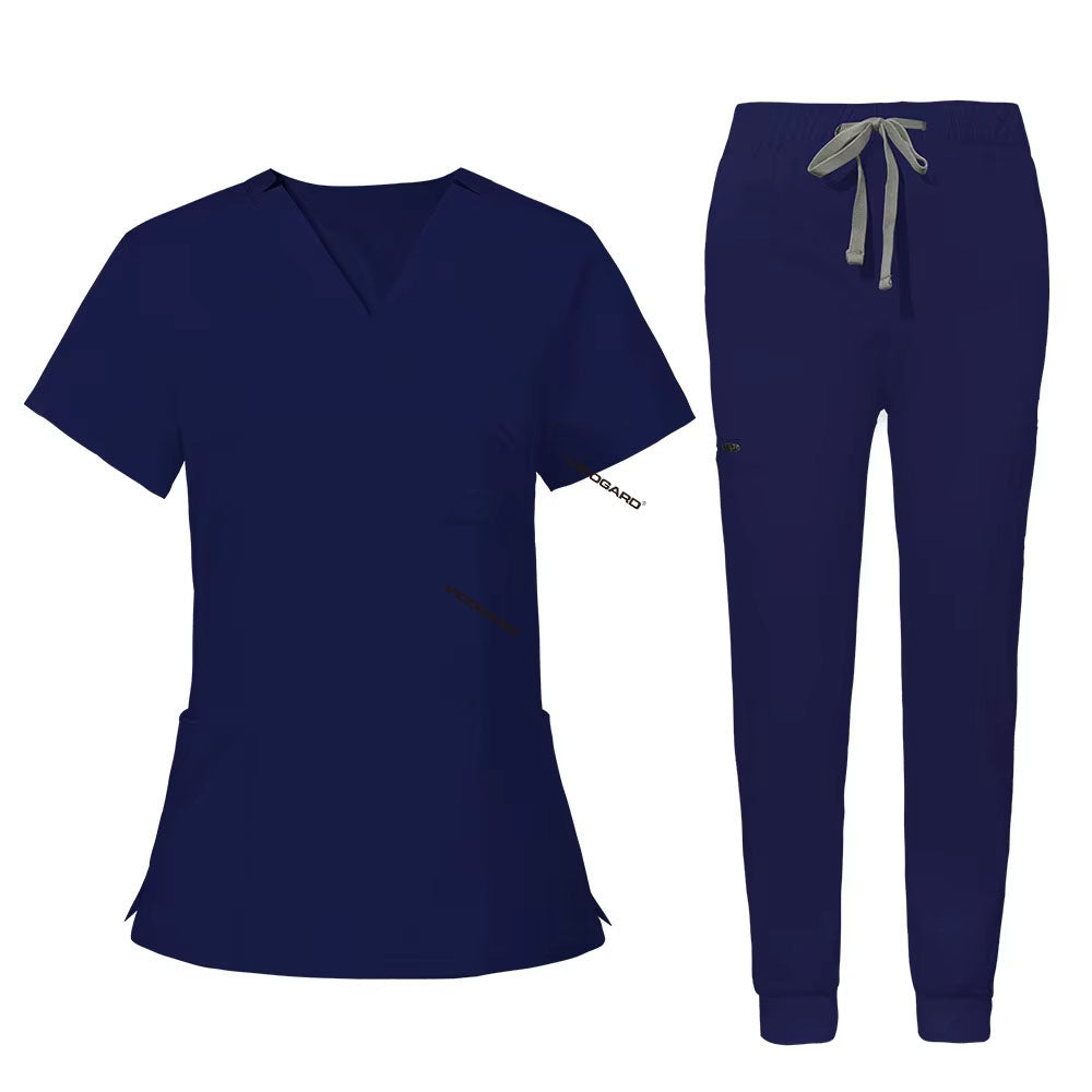 Flat lay of Navy Blue utility scrub set featuring 3-pocket top and 8-pocket jogger pants
