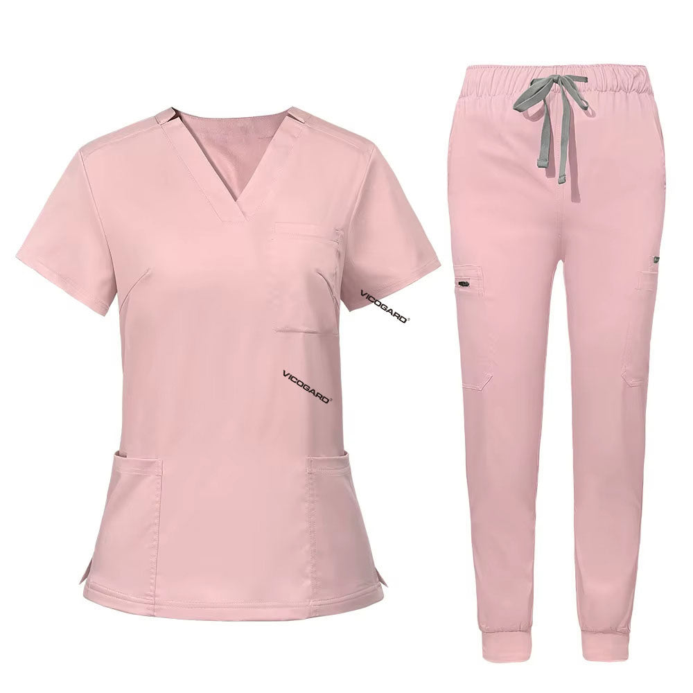 Flat lay of Pink utility scrub set featuring 3-pocket top and 8-pocket jogger pants