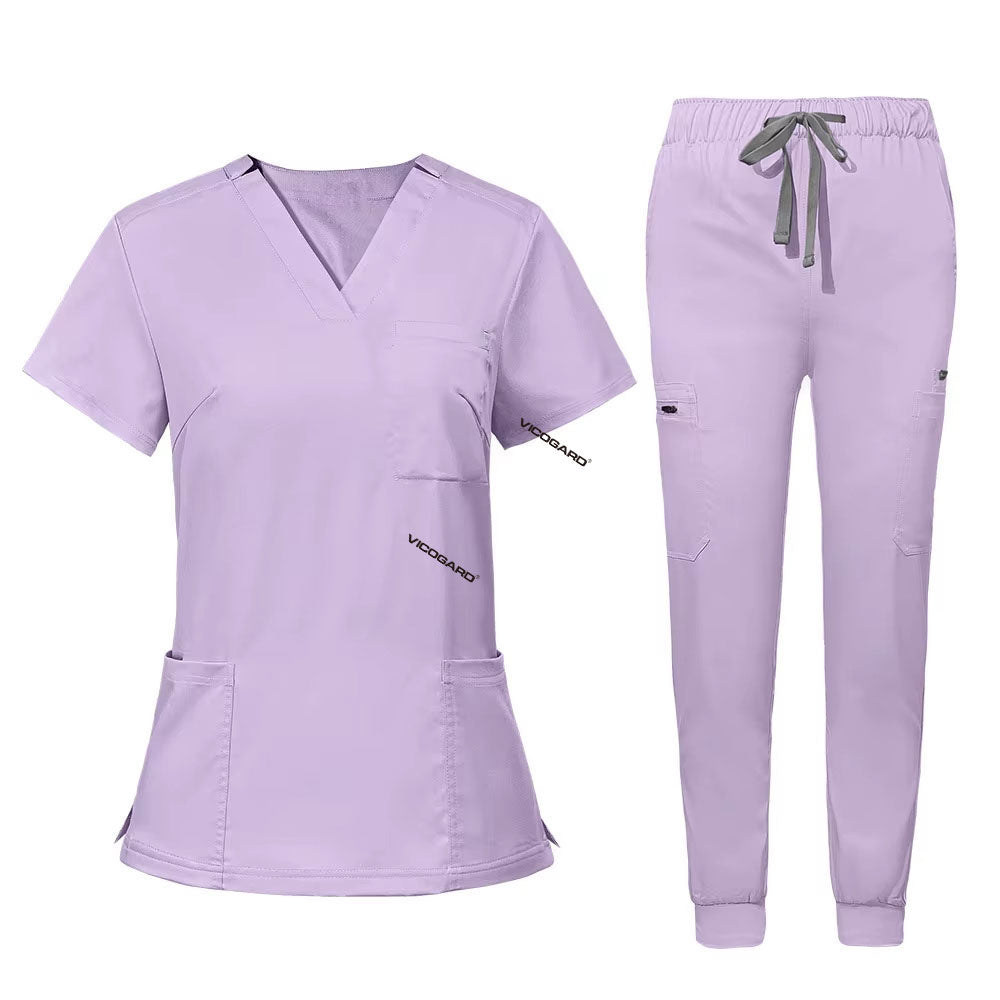 Flat lay of Lavender utility scrub set featuring 3-pocket top and 8-pocket jogger pants