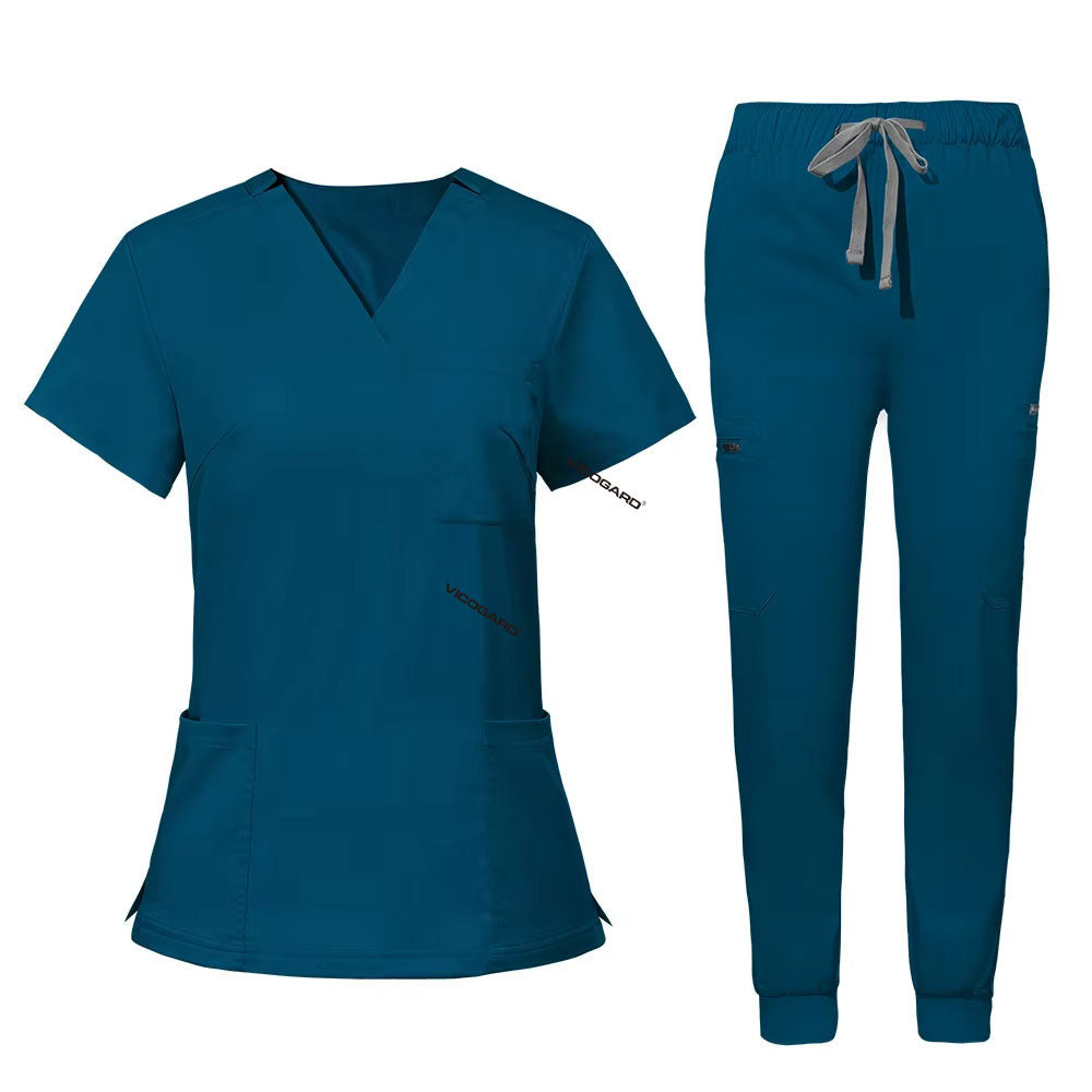 Flat lay of Caribbean Blue utility scrub set featuring 3-pocket top and 8-pocket jogger pants