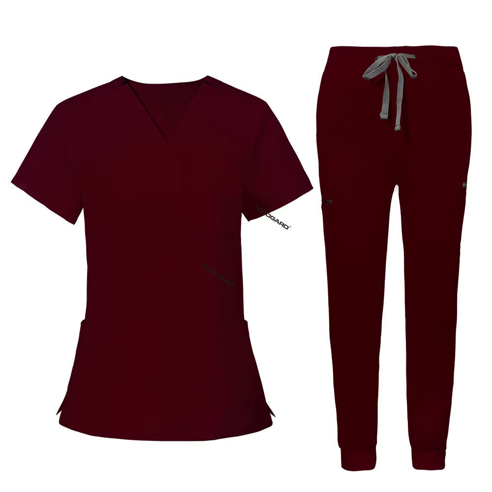 Flat lay of Burgundy utility scrub set featuring 3-pocket top and 8-pocket jogger pants