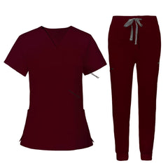 Flat lay of Burgundy utility scrub set featuring 3-pocket top and 8-pocket jogger pants