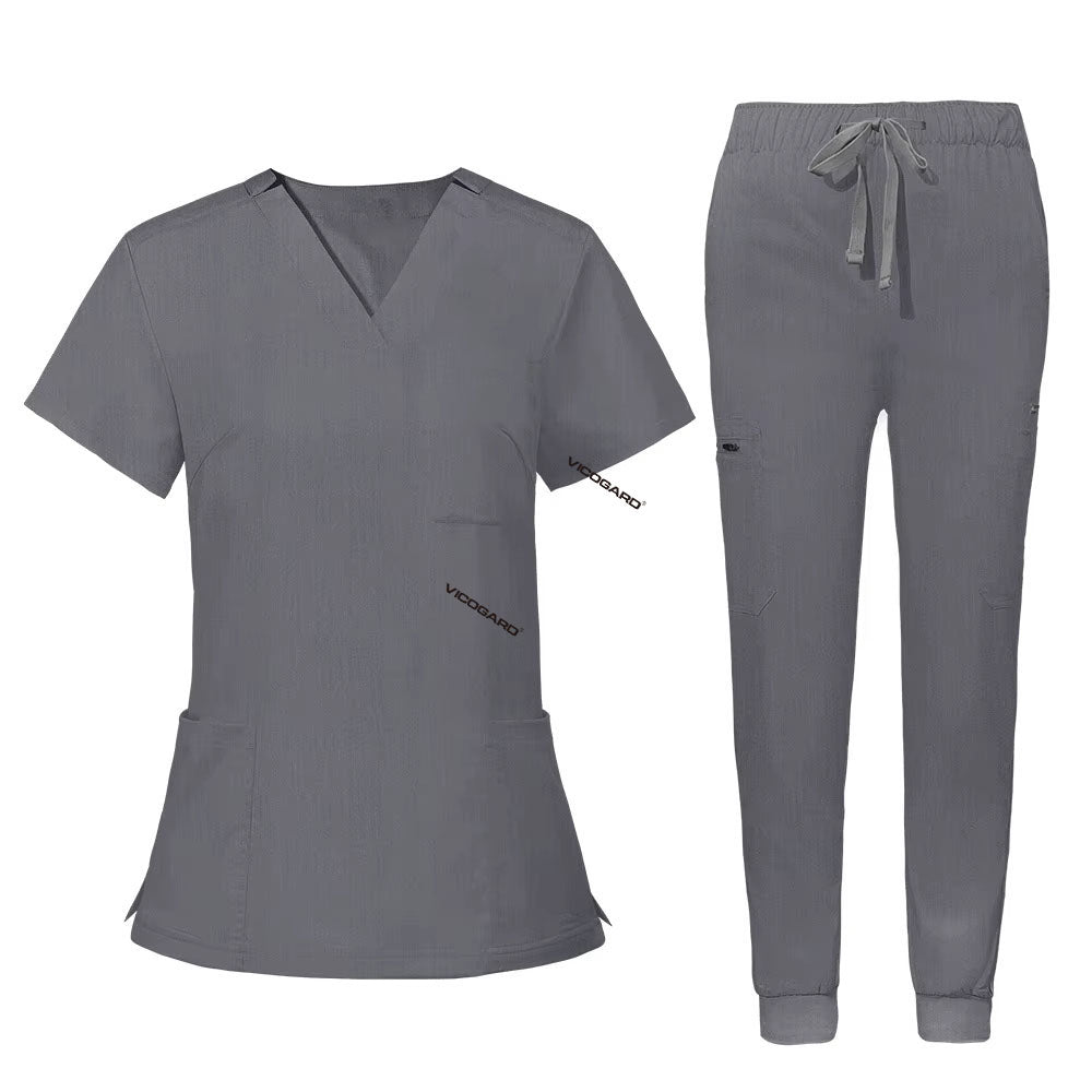 Flat lay of Gray utility scrub set featuring 3-pocket top and 8-pocket jogger pants