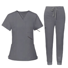 Flat lay of Gray utility scrub set featuring 3-pocket top and 8-pocket jogger pants