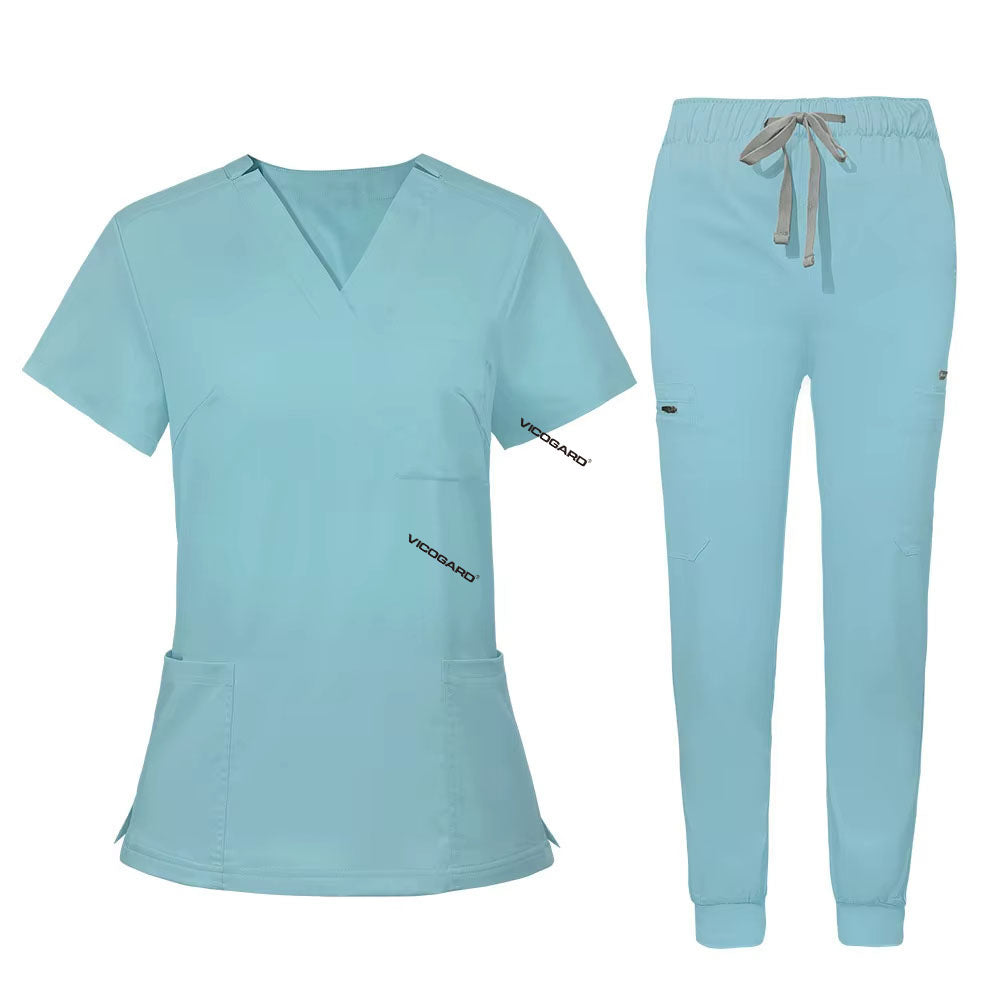 Flat lay of Ceil Blue utility scrub set featuring 3-pocket top and 8-pocket jogger pants