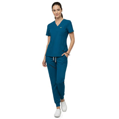 Model demonstrating deep cargo pocket storage on Caribbean Blue 8-pocket scrub joggers