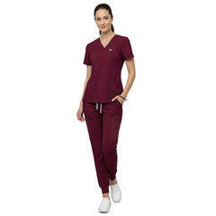 Model demonstrating deep cargo pocket storage on Burgundy 8-pocket scrub joggers