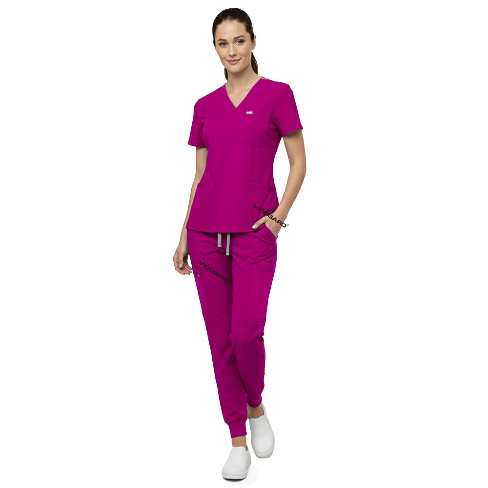 Model demonstrating deep cargo pocket storage on Rose Pink 8-pocket scrub joggers