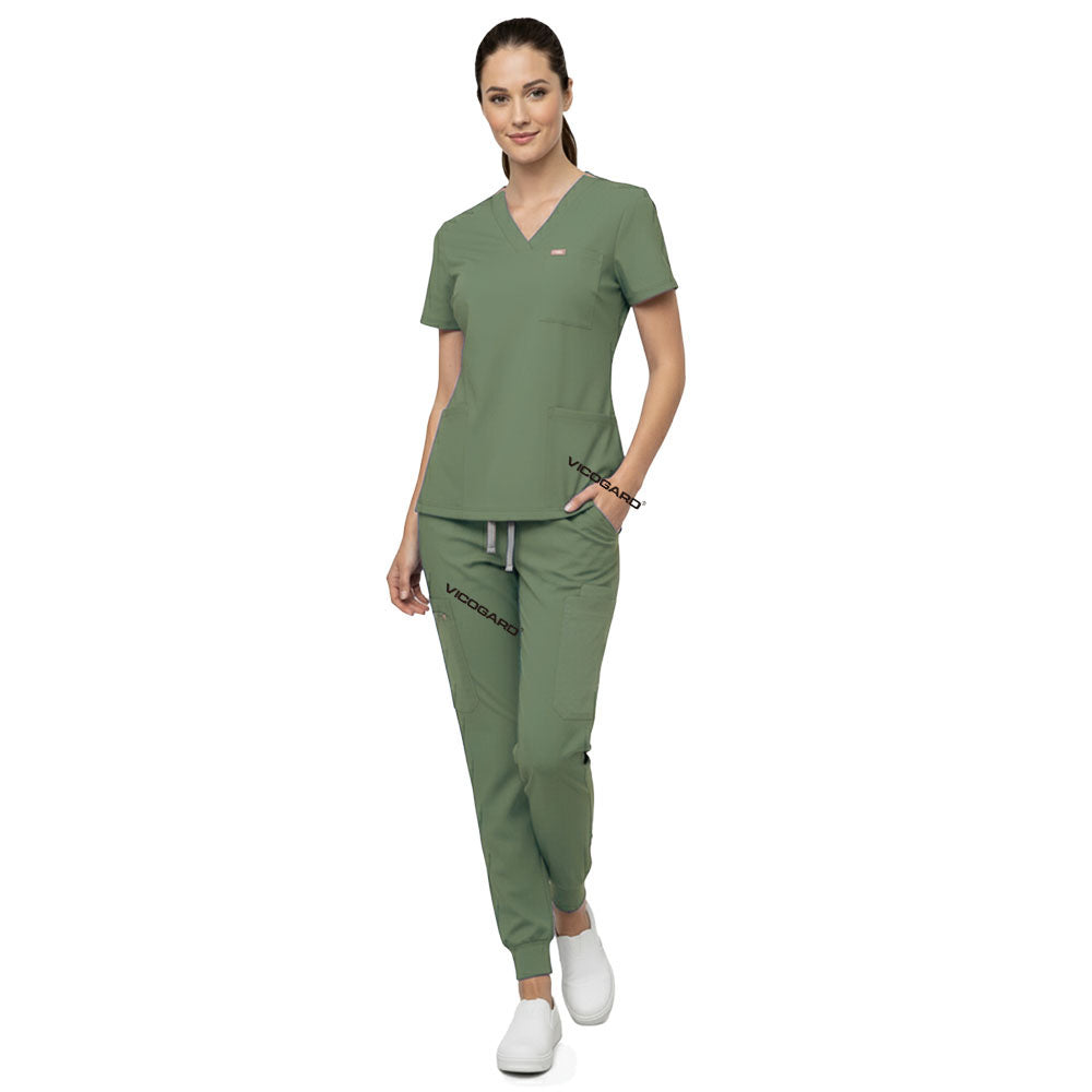 Model demonstrating deep cargo pocket storage on Fruit Green 8-pocket scrub joggers