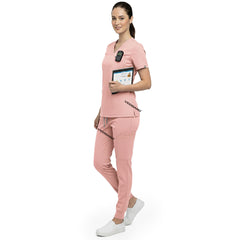 Side profile of nurse holding medical tools wearing Pink rayon scrubs showing athletic fit