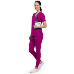 Side profile of nurse holding medical tools wearing Rose Pink rayon scrubs showing athletic fit