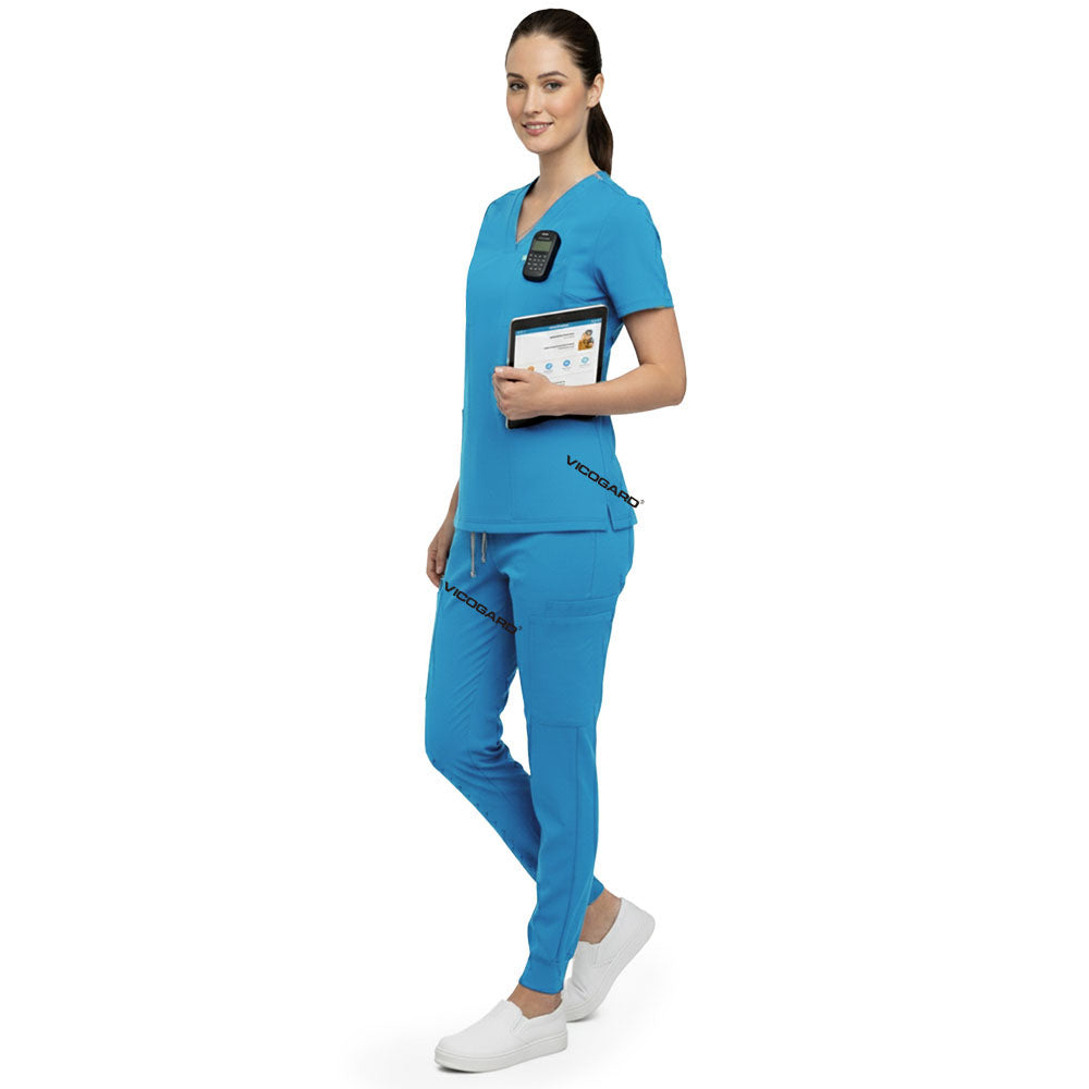 Side profile of nurse holding medical tools wearing Royal Blue rayon scrubs showing athletic fit