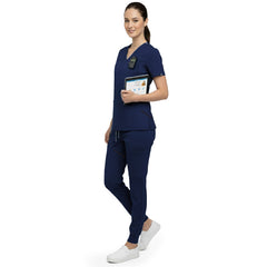Side profile of nurse holding medical tools wearing Navy Blue rayon scrubs showing athletic fit