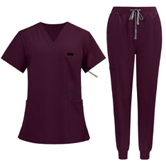 Flat lay of Burgundy medical uniform featuring curved hem top and zipper pocket jogger pants