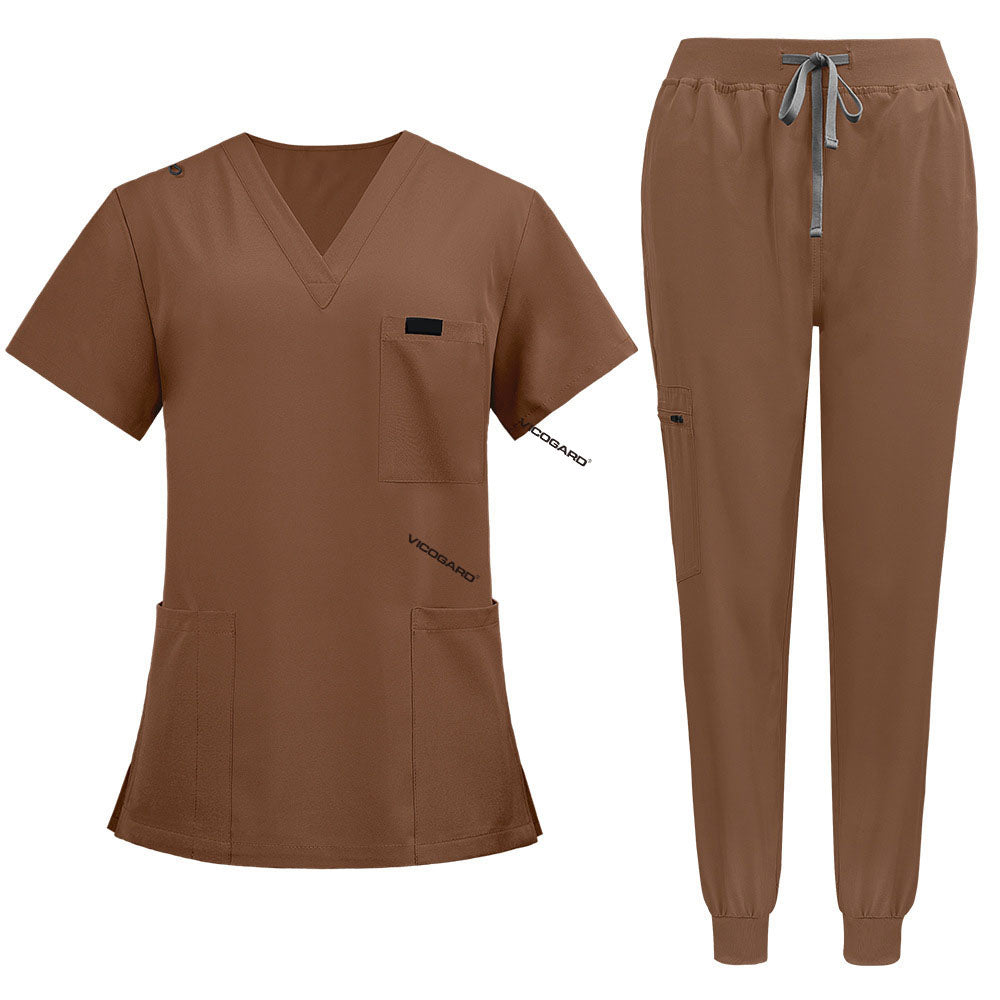 Flat lay of Coffee medical uniform featuring curved hem top and zipper pocket jogger pants