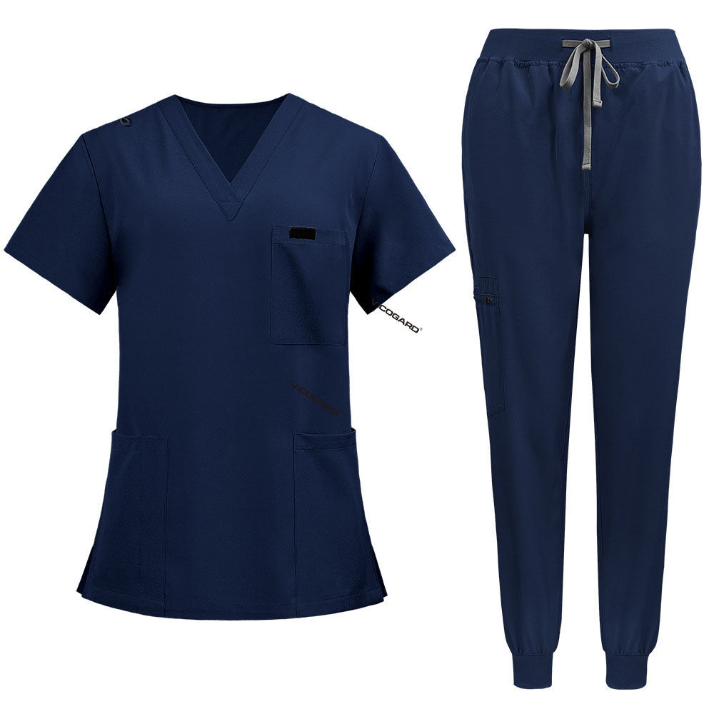 Flat lay of Galaxy Blue medical uniform featuring curved hem top and zipper pocket jogger pants