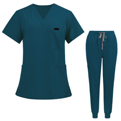 Flat lay of Caribbean Blue medical uniform featuring curved hem top and zipper pocket jogger pants