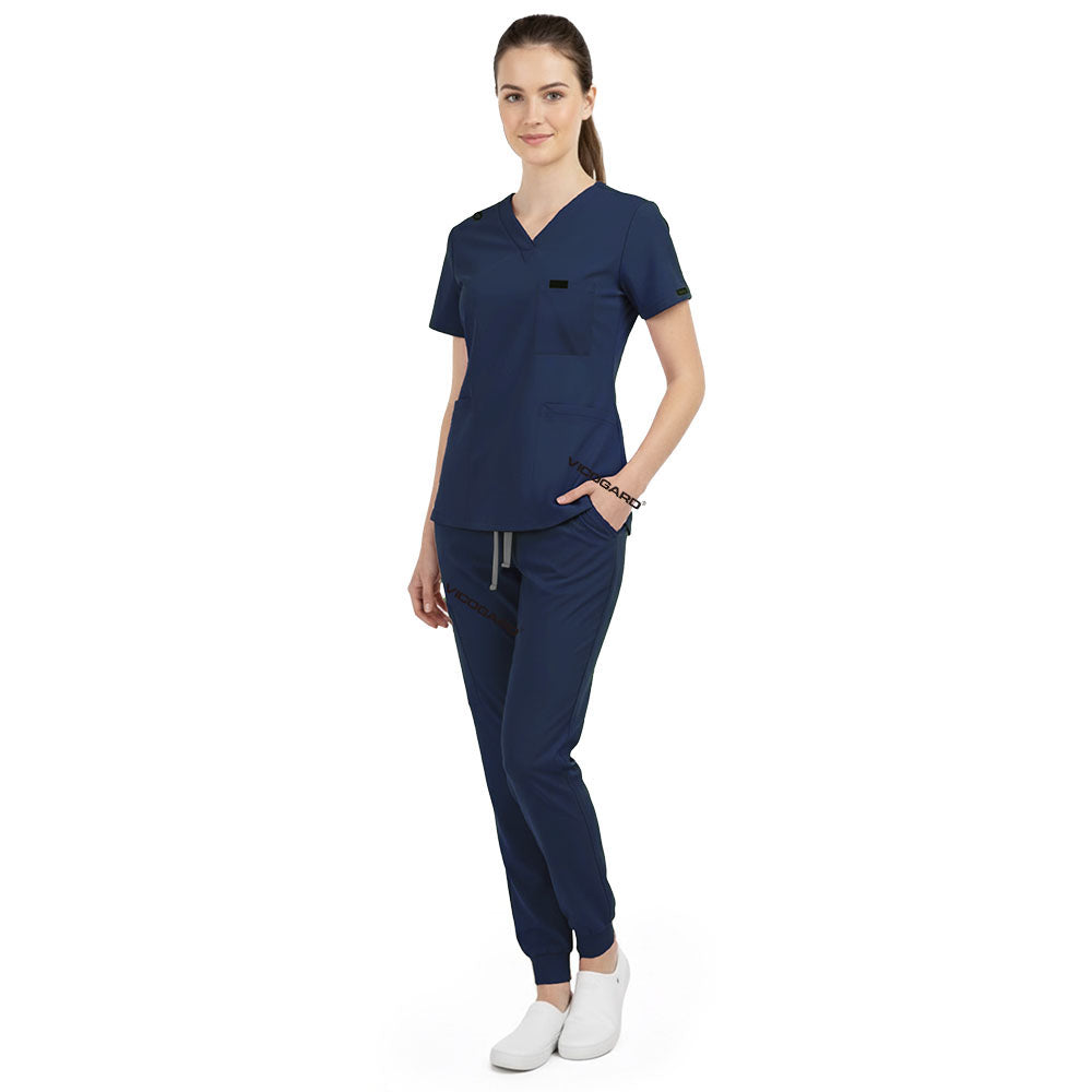 Side view of model using pockets on Galaxy Blue scrub pants, showing storage depth