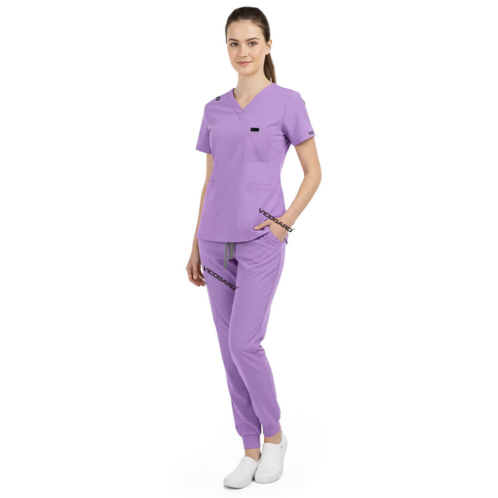 Side view of model using pockets on Lavender scrub pants, showing storage depth