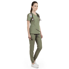 Side view of veterinary nurse working in Fruit Green scrubs, showing energetic professional look
