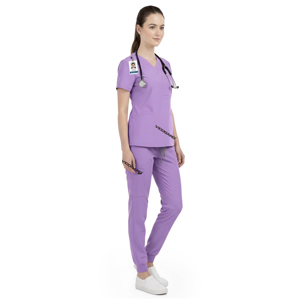 Side view of caregiver working in Lavender scrubs, showing calming professional look