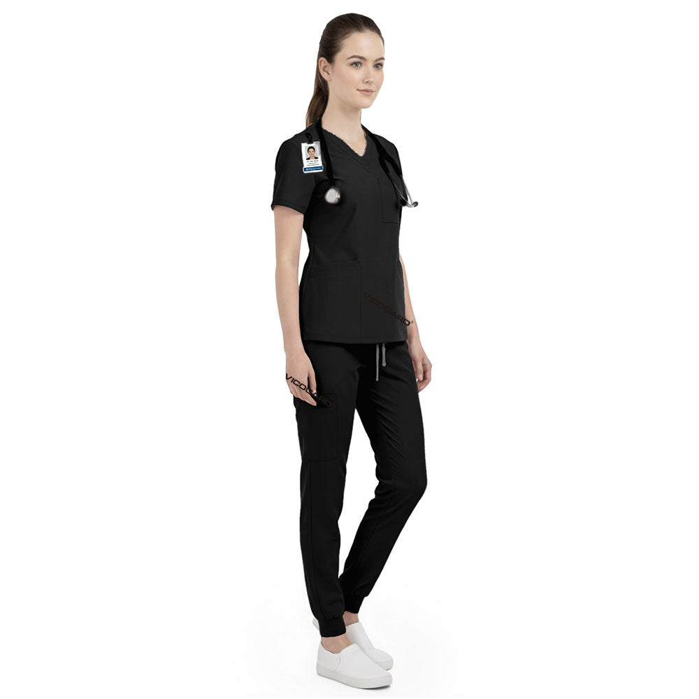 Side view of beauty professional working in Black scrubs, showing elegant professional look