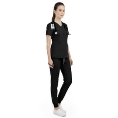 Side view of beauty professional working in Black scrubs, showing elegant professional look