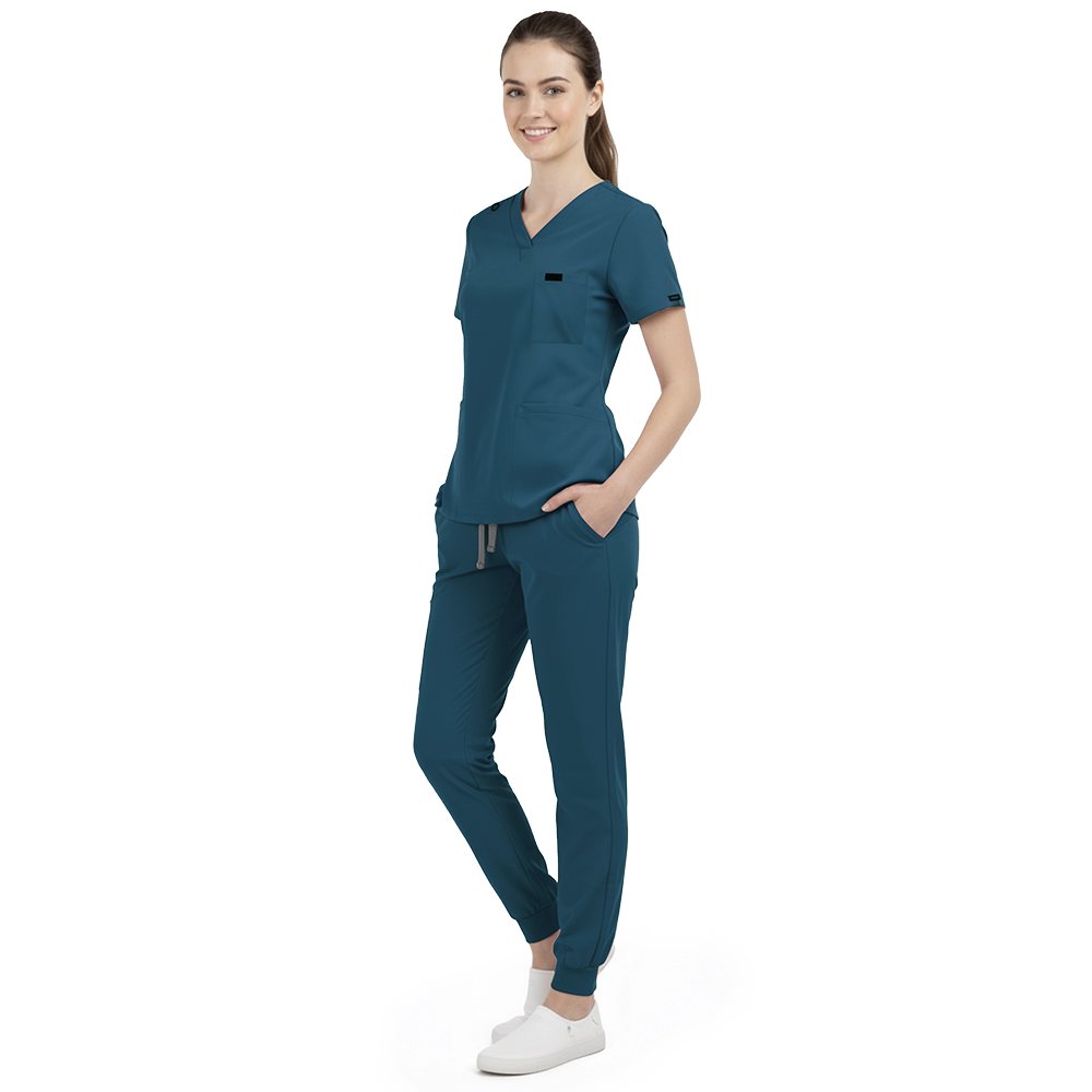 Front view of model with both hands in pockets, demonstrating relaxed fit of Caribbean Blue scrubs