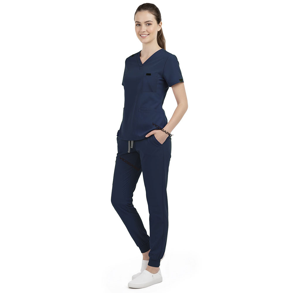 Front view of model with both hands in pockets, demonstrating relaxed fit of Galaxy Blue scrubs