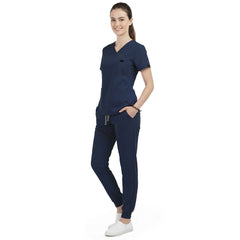 Front view of model with both hands in pockets, demonstrating relaxed fit of Galaxy Blue scrubs