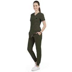 Front view of model with both hands in pockets, demonstrating relaxed fit of Army Green scrubs