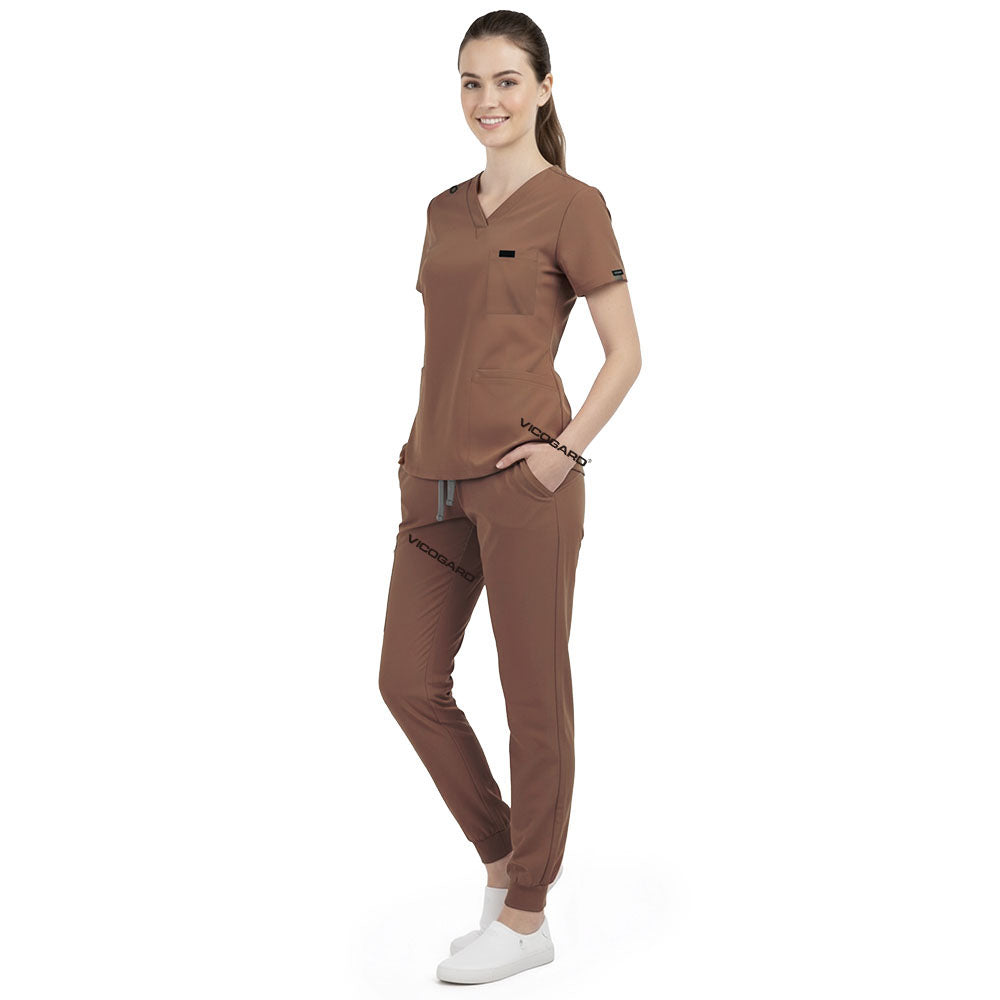 Front view of model with both hands in pockets, demonstrating relaxed fit of Coffee scrubs