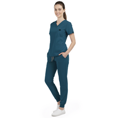 Front view of model with both hands in pockets, demonstrating relaxed fit of Caribbean Blue scrubs