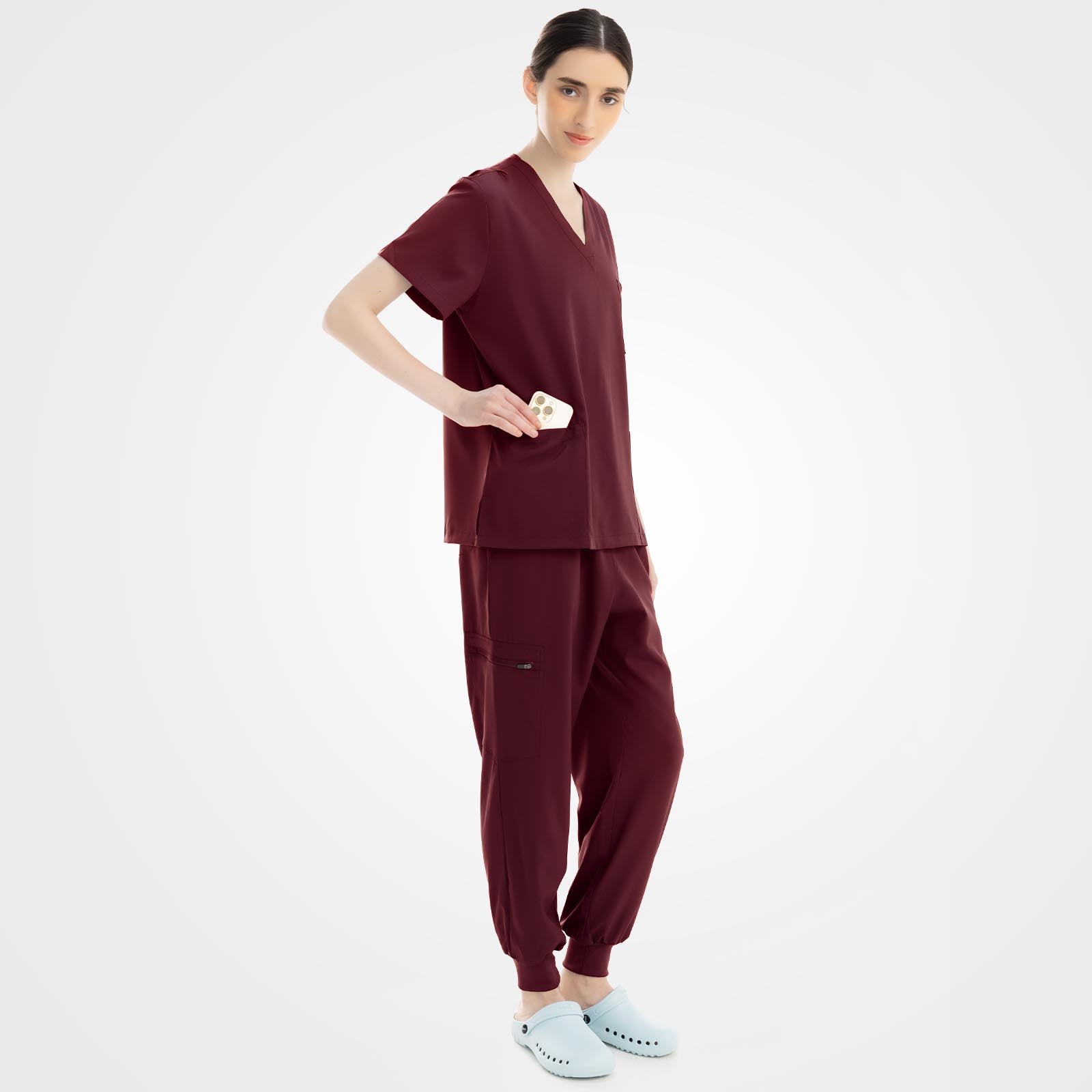 Burgundy medical spa scrubs side profile with streamlined zippered pocket
