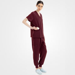 Burgundy medical spa scrubs side profile with streamlined zippered pocket