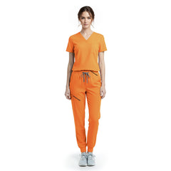 Vicogard Mango Yellow performance jogger scrub set front view, vibrant V-neck top with badge loop